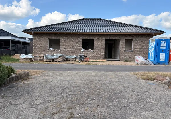 Neubau Winkelbungalow in Osterbrock, Rohbau mit fertig eingedecktem Dach